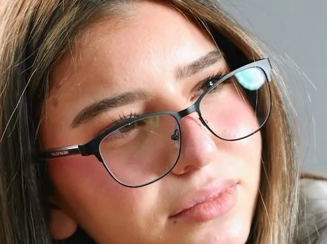 Close-up of the black cat-eye frame with an upswept brow line