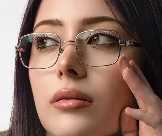 Close-up of the gold-tone rectangular frame and its dark temples