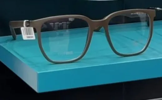 Brown matte square optical frame on a turquoise display shelf